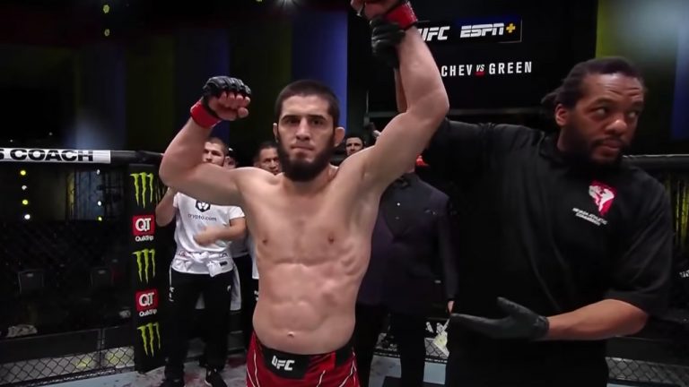 Islam Makhachev has his hand raised by referee Herb Dean after a UFC win. (YouTube/UFC)