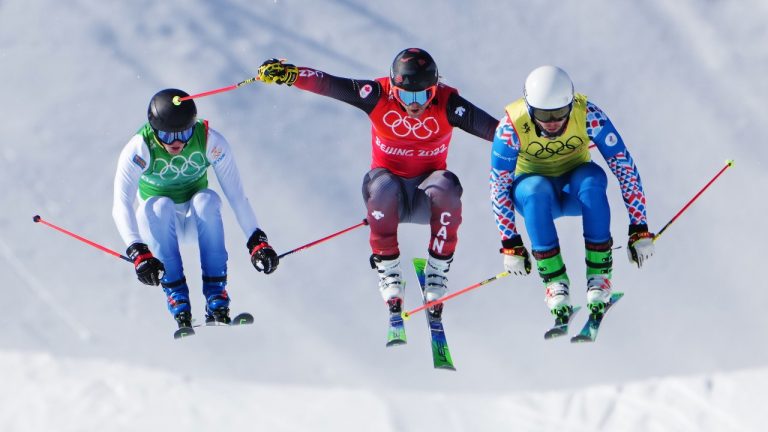 Sweden's David Mobaerg, left to right, Canada's Brady Leman and Russian Olympic Committee's Sergey Ridzik compete in the freestyle men's ski cross 1/8 finals during the Beijing Winter Olympic Games, in Zhangjiakou, China, Friday, Feb. 18, 2022. (Sean Kilpatrick/THE CANADIAN PRESS)