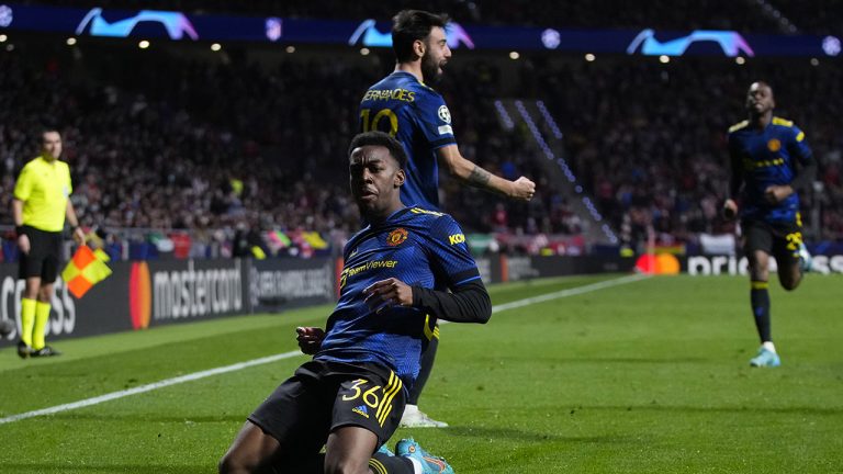 Manchester United's Anthony Elanga, bottom, celebrates after scoring his side's first goal during the Champions League, round of 16, first leg soccer match between Atletico Madrid and Manchester United. (AP)