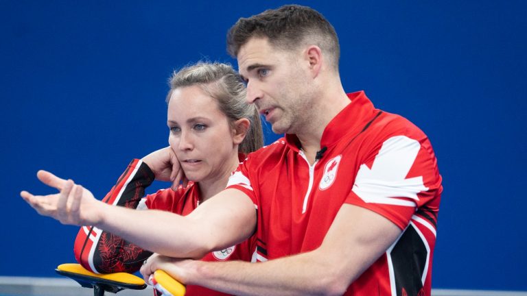 Canada’s Rachel Homan and John Morris discuss a shot during preliminary round mixed curling against Czech Republic Sunday, February 6, 2022 at the 2022 Winter Olympics in Beijing. (Ryan Remiorz/THE CANADIAN PRESS)