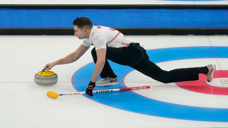 John Morris throws a rock during the mixed doubles curling match against Sweden at the Beijing Winter Olympics Saturday, Feb. 5, 2022, in Beijing. (Brynn Anderson/AP Photo)
