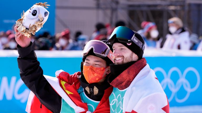Gold medalist Su Yiming, left, of China, and bronze medalist Canada's Max Parrot pose for a photo following the men's snowboarding big air final at the Beijing Olympic Winter Games in Beijing, Tuesday, Feb. 15, 2022. (Paul Chiasson/THE CANADIAN PRESS)