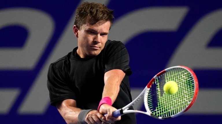 Stefan Kozlov, of the U.S., returns a ball during a match against Grigor Dimitrov, of Bulgaria, at the Mexican Open tennis tournament in Acapulco, Mexico, Monday, Feb. 21, 2022. (Eduardo Verdugo/AP)