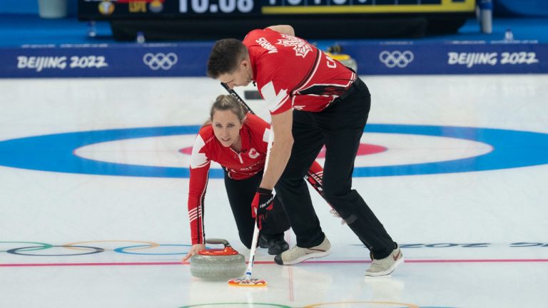 Canada’s Rachel Homan delivers a rock as John Morris sweeps during preliminary round mixed curling against Czech Republic Sunday, February 6, 2022 at the 2022 Winter Olympics in Beijing. (Ryan Remiorz/CP)