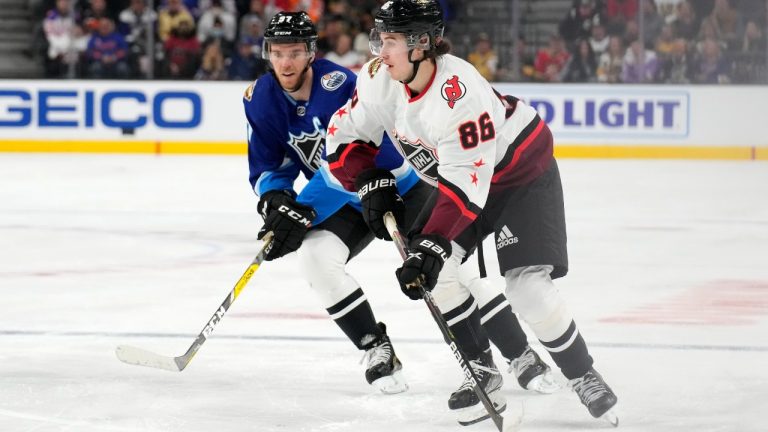 Metropolitan Division's Jack Hughes, of the New Jersey Devils, right, skates in front of Pacific Division's Connor McDavid, of the Edmonton Oilers, during the second period of a semifinal NHL All-Star hockey game Saturday, Feb. 5, 2022, in Las Vegas. (Rick Scuteri/AP)