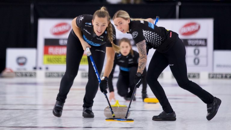 Agnes Knochenhauer (left) and Sofia Mabergs (right) sweep a stone for Anna Hasselborg (centre) during the Boost National women's final on Nov. 7, 2021. (Anil Mungal)