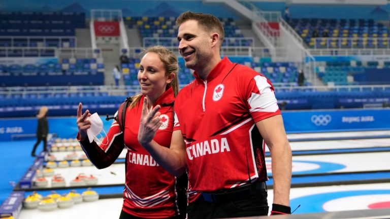 Canada's Rachel Homan and John Morris pose for a photograph, after winning the mixed doubles match against Switzerland, at the 2022 Winter Olympics, Friday, Feb. 4, 2022, in Beijing. (Nariman El-Mofty/AP)