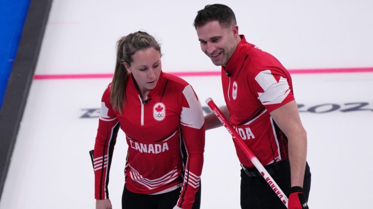 Canada's Rachel Homan and John Morris compete, during mixed doubles match against Switzerland, at the 2022 Winter Olympics, Friday, Feb. 4, 2022, in Beijing. (Nariman El-Mofty/AP)