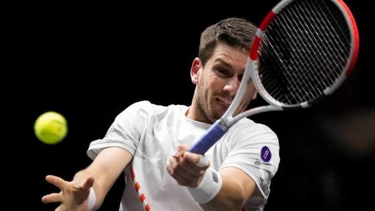Cameron Norrie of Britain plays a shot against Felix Auger-Aliassime of Canada in their quarterfinal men's singles match of the ABN AMRO world tennis tournament at Ahoy Arena in Rotterdam, Netherlands, Friday, Feb. 11, 2022. (Peter Dejong/AP)
