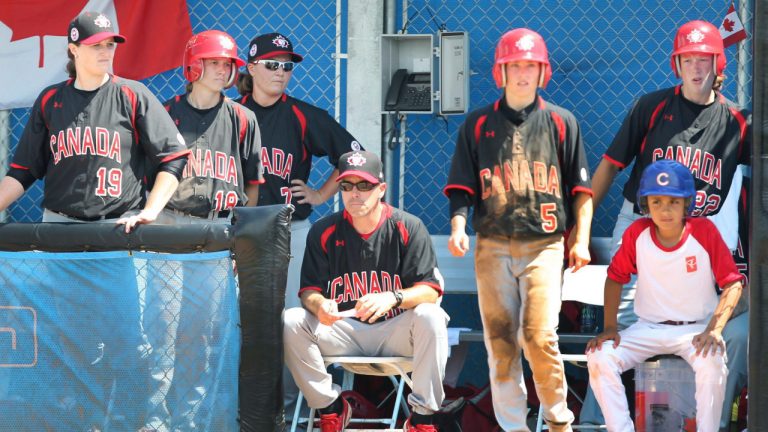 Team Canada manager Andre Lachance sits stoically on a chair watching the ninth inning and the United States beat Canada for the gold medal in women's baseball at the Pan American Games in Ajax, Ont., on Sunday, July 26, 2015. (Fred Thornhill/CP) 