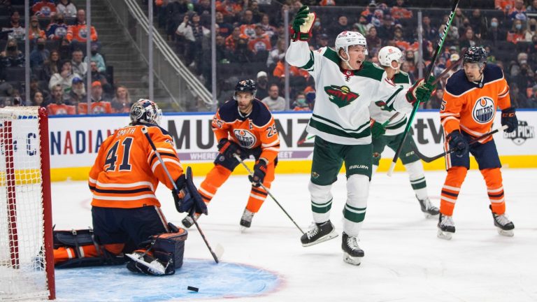 Minnesota Wild's Matt Boldy (12) reacts as the puck goes in past Edmonton Oilers goalie Mike Smith (41) during first period NHL action in Edmonton, Sunday, Feb. 20, 2022. (Jason Franson/CP)
