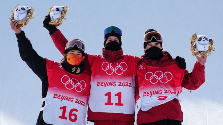 Silver medallist, Su Yiming of China, left to right, gold medallist Max Parrot, of Bromont, Que., and fellow Canadian and bronze medallist Canada's Mark McMorris, of Regina, celebrate on the podium with their medals following the men's slopestyle final at the Beijing Winter Olympic Games, in Zhangjiakou, China, Monday, Feb. 7, 2022. (Sean Kilpatrick/THE CANADIAN PRESS)