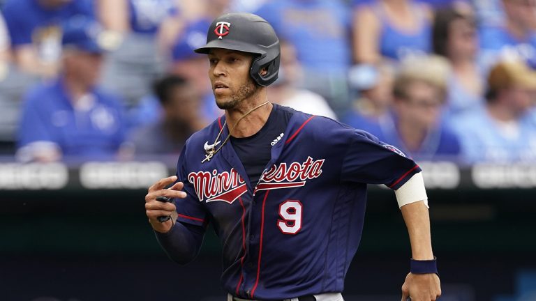 Minnesota Twins' Andrelton Simmons runs home to score on a double by Miguel Sano during the third inning of a baseball game against the Kansas City Royals. (Charlie Riedel/AP)