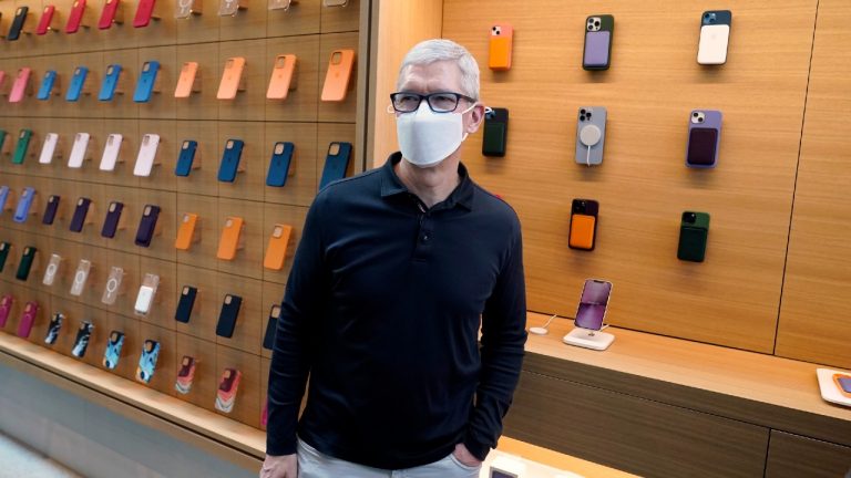 Apple CEO Tim Cook stands in front of company products during a visit to an Apple Store at The Grove, Friday, Nov. 19, 2021, in Los Angeles. (Marcio Jose Sanchez/AP)
