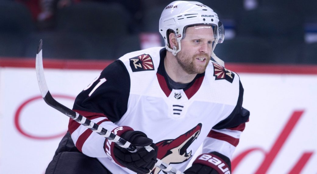 Arizona Coyotes' Phil Kessel (81) fights for control of the puck