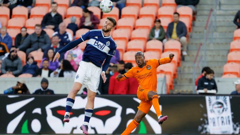 Vancouver Whitecaps defender Tristan Blackmon (6) goes for a header over Houston Dynamo midfielder Fafa Picault, right, during the first half of an MLS soccer match Saturday, March 12, 2022, in Houston. (Michael Wyke/AP)