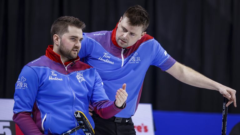 Team Wild Card Two skip Matt Dunstone, left, and third Braeden Moskowy discuss strategy while playing Team Prince Edward Island at the Tim Hortons Brier. (Jeff McIntosh/CP)