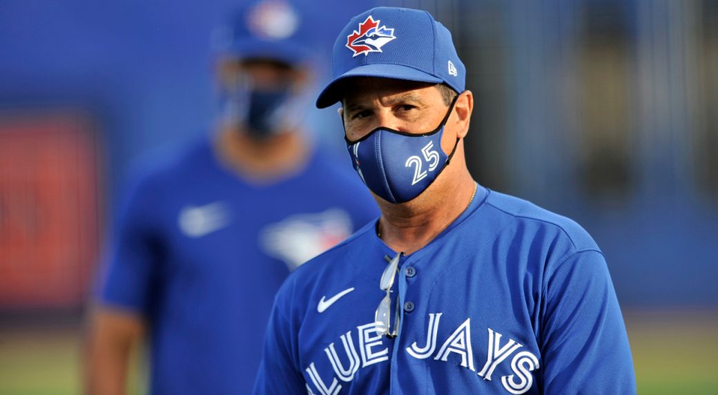Jordan Romano of the Toronto Blue Jays looks on from the dugout