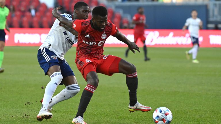 Toronto FC's Kemar Lawrence, right, keeps the ball aways from D.C. United's Nigel Robertha during first half MLS soccer action in Toronto on Sunday, Nov. 7, 2021. THE CANADIAN PRESS/Jon Blacker