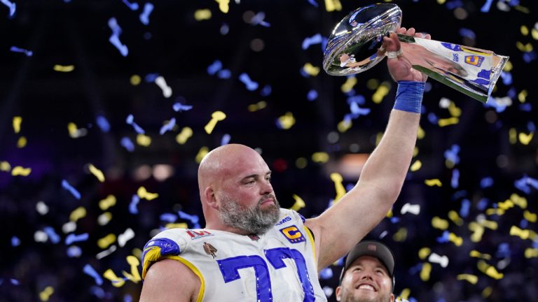 Los Angeles Rams offensive tackle Andrew Whitworth holds up the Lombardi Trophy after the Rams defeated the Cincinnati Bengals in the Super Bowl 56. (Mark J. Terrill/AP)