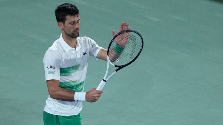 Serbia's Novak Djokovic reacts after he lost a point against Czech Republic's Jiri Vesely during a quarterfinal match of the Dubai Duty Free Tennis Championship in Dubai, United Arab Emirates, Thursday, Feb. 24, 2022. (Ebrahim Noroozi/AP)