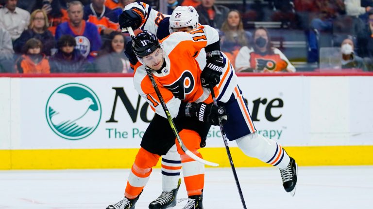 Philadelphia Flyers' Travis Konecny, left, and Edmonton Oilers' Darnell Nurse battle for the puck during the second period of an NHL hockey game, Tuesday, March 1, 2022, in Philadelphia. (AP Photo/Matt Slocum)