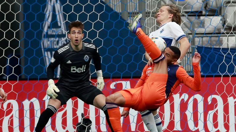Vancouver Whitecaps goalkeeper Thomas Hasal looks on as Vancouver Whitecaps' Florian Jungwirth collides with New York City FC's Alexander Callens.(Jeff Vinnick/CP)