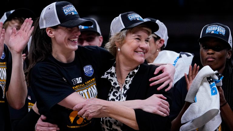 Iowa head coach Lisa Bluder, right and Iowa guard Caitlin Clark (22) celebrate after winning the championship of the Big Ten Conference tournament in an NCAA college basketball game against Indiana in Indianapolis, Sunday, March 6, 2022. Iowa defeated Indiana 74-67. (AP Photo/Michael Conroy)