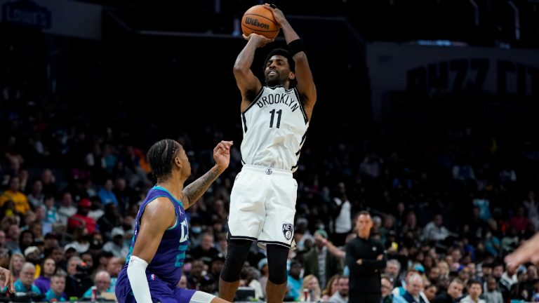 Brooklyn Nets guard Kyrie Irving scores over Charlotte Hornets forward P.J. Washington.(Chris Carlson/AP)