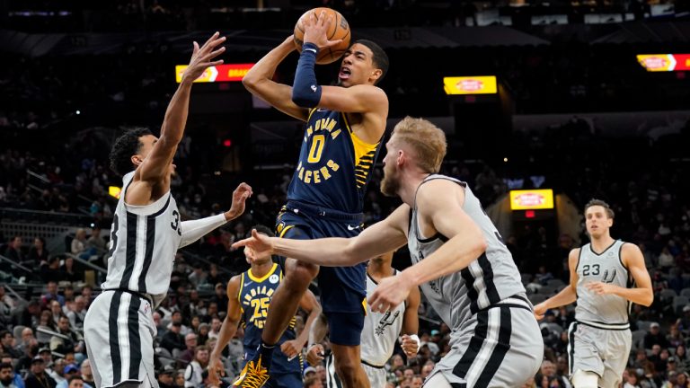 Indiana Pacers' Tyrese Haliburton drives between San Antonio Spurs' Tre Jones, and Jock Landale. (Chuck Burton/AP)