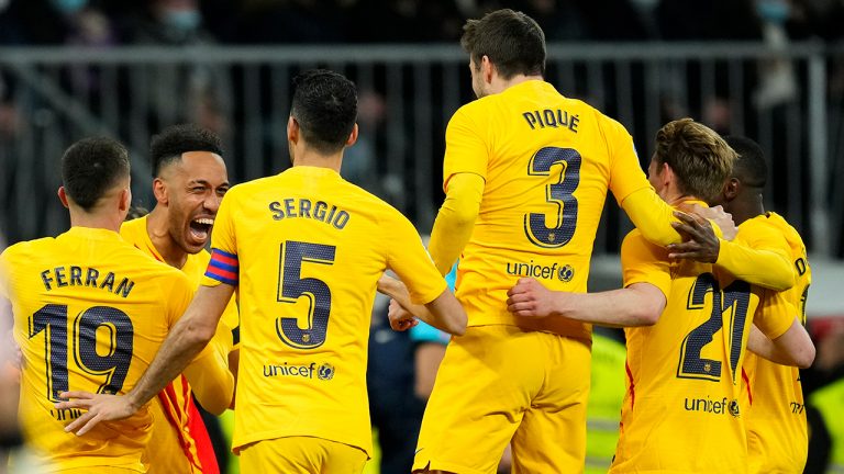 Barcelona's Pierre-Emerick Aubameyang, second left, celebrates with his teammates after scoring his side's fourth goal during a Spanish La Liga soccer match between Rial Madrid and FC Barcelona at the Santiago Bernabeu stadium in Madrid, Spain, Sunday, March 20, 2022. (Manu Fernandez/AP)