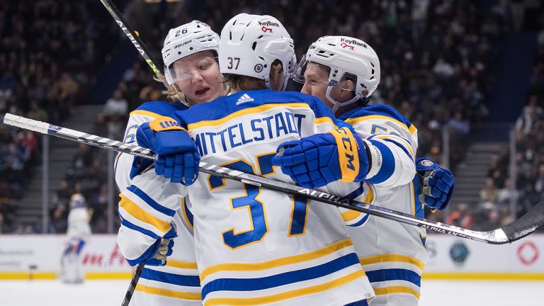 Buffalo Sabres' Jeff Skinner, right, celebrates his goal with teammates Rasmus Dahlin, of Sweden, left, and Casey Mittelstadt during the second period of an NHL hockey game against the Vancouver Canucks, in Vancouver, B.C., Sunday, March 20, 2022. (Darryl Dyck/CP)