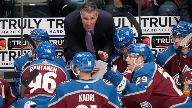 Colorado Avalanche coach Jared Bednar confers with players during the third period of the team's NHL hockey game against the Vancouver Canucks on Wednesday, March 23, 2022, in Denver. (AP)
