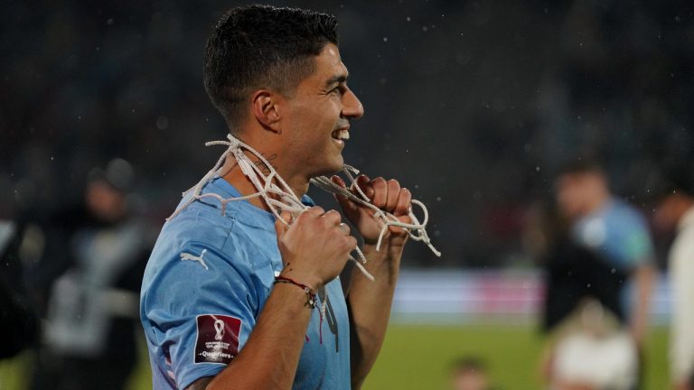 Uruguay's Luis Suarez celebrates with a piece of the goal net his teamÂ´s 1-0 victory over Peru in a qualifying soccer match for the FIFA World Cup Qatar 2022 in Montevideo, Uruguay, Thursday, March 24, 2022. (AP Photo/Matilde Campodonico, Pool)