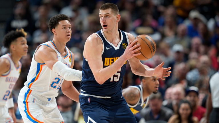 Denver Nuggets centre Nikola Jokic, fields a pass as Oklahoma City Thunder forward Isaiah Roby defends. (David Zalubowski/AP)