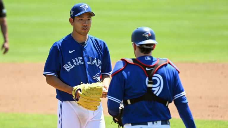 Toronto Blue Jays starter Yusei Kikuchi gets a visit to the mound by catcher Danny Jansen (9) during the second inning of a spring training baseball game at TD Ballpark, in Dunedin, Fla., Sunday, March 27, 2022. (CP)