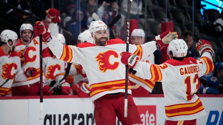 Calgary Flames defenseman Erik Gudbranson, left, celebrates his goal with left wing Johnny Gaudreau during the second period of the team's NHL hockey game against the Colorado Avalanche on Saturday, March 5, 2022, in Denver. (David Zalubowski/AP)