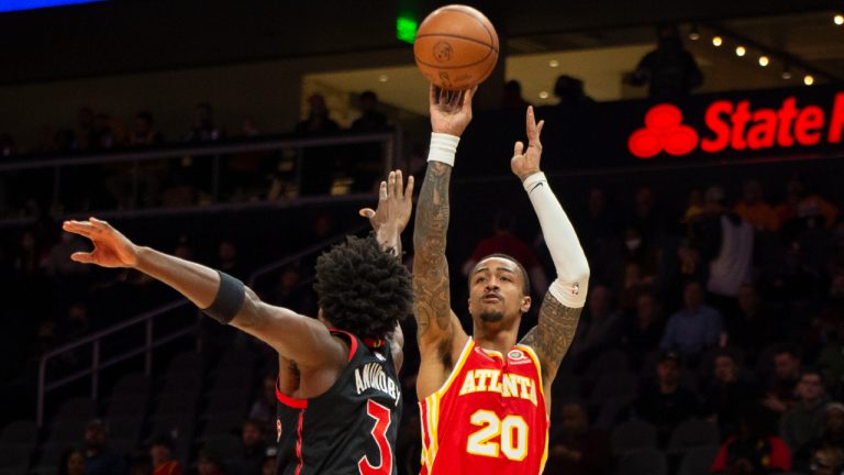 Atlanta Hawks forward John Collins (20) shoots a jumper over Toronto Raptors forward OG Anunoby (3) during the first half of an NBA basketball game Monday, Jan. 31, 2022, in Atlanta. (Hakim Wright Sr./AP)