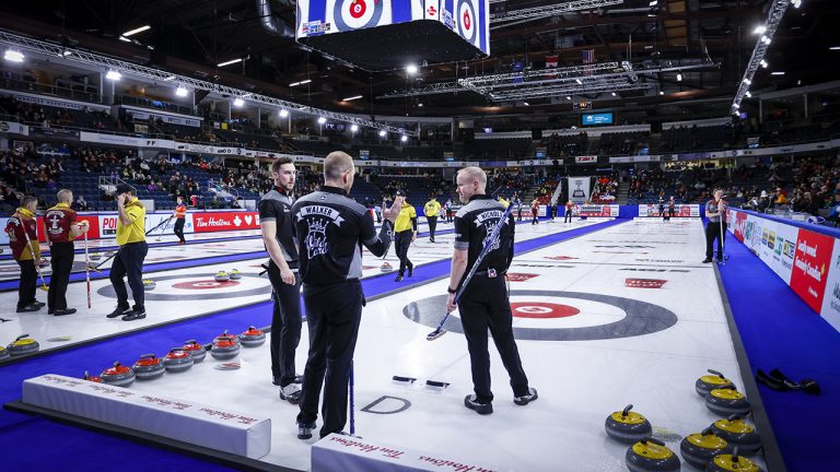Team Wild Card One second Brett Gallant, left, lead Geoff Walker, centre, and third Mark Nichols discuss strategy while playing Team Northwest Territories at the Tim Hortons Brier. (Jeff McIntosh/CP)