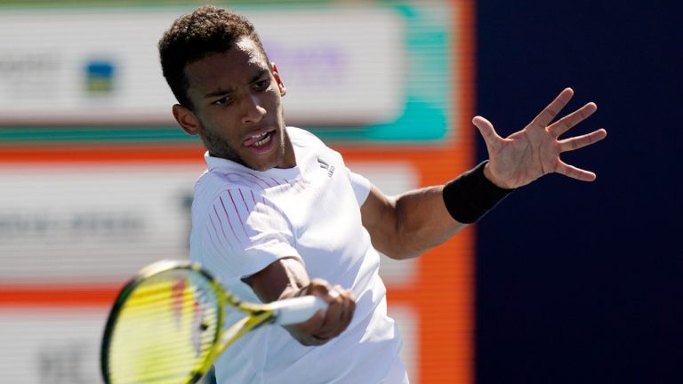 Felix Auger-Aliassime, of Canada, returns a shot from Miomir Kecmanovic, of Serbia, during the Miami Open tennis tournament, Saturday, March 26, 2022, in Miami Gardens, Fla. (Wilfredo Lee/AP)
