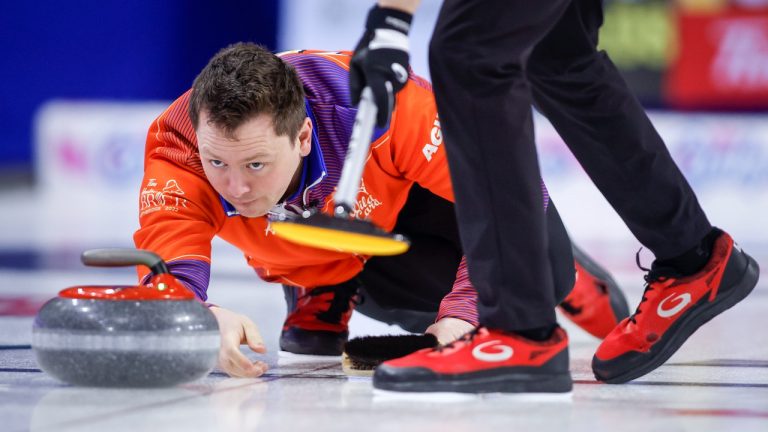 Team Wild Card Three skip Jason Gunnlaugson makes a shot against Team Northern Ontario at the Tim Hortons Brier in Lethbridge, Alta., Saturday, March 5, 2022. Jeff McIntosh/THE CANADIAN PRESS)