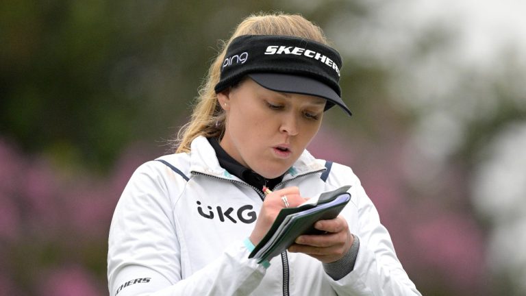 Brooke Henderson marks her scorecard after hitting her tee shot on the 16th hole during the third round of the Tournament of Champions LPGA golf tournament, Saturday, Jan. 22, 2022, in Orlando, Fla. (Phelan M. Ebenhack/AP Photo)