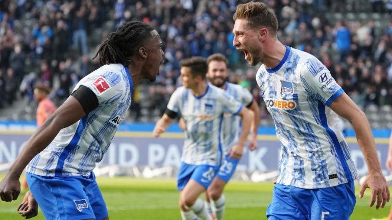 Hertha's Niklas Stark, right, celebrates scoring with teammate Dedryck Boyata during the Bundesliga soccer match between Hertha BSC and TSG 1899 Hoffenheim at Olympiastadion, Berlin, Saturday March 19, 2022. (Soeren Stache/dpa via AP)