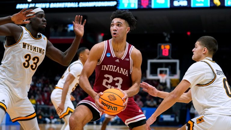 Indiana forward Trayce Jackson-Davis (23) drives past Wyoming's Graham Ike (33) and Drake Jeffries (0) during the second half of a First Four game in the NCAA men's college basketball tournament Tuesday, March 15, 2022, in Dayton, Ohio. (Jeff Dean/AP Photo)