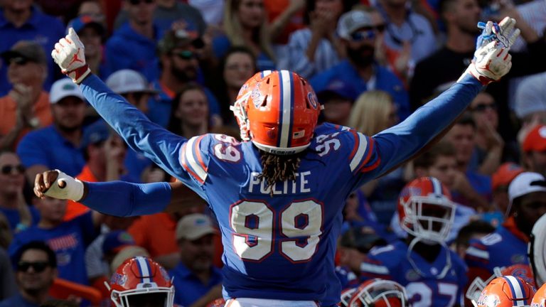 Florida defensive lineman Jachai Polite (99) does a chest bump with a teammate after stopping a South Carolina drive late in fourth quarter in an NCAA college football game. (John Raoux/AP)
