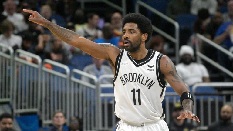 Brooklyn Nets guard Kyrie Irving (11) acknowledges a teammate after scoring a 3-pointer during the first half of an NBA basketball game against the Orlando Magic, Tuesday, March 15, 2022, in Orlando, Fla. (Phelan M. Ebenhack/AP Photo)