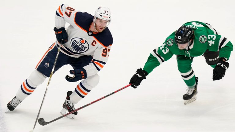 Edmonton Oilers centre Connor McDavid (97) and Dallas Stars left wing Marian Studenic (43) battle it out during the first period of an NHL hockey game in Dallas, Tuesday, March 22, 2022. (LM Otero/AP Photo)