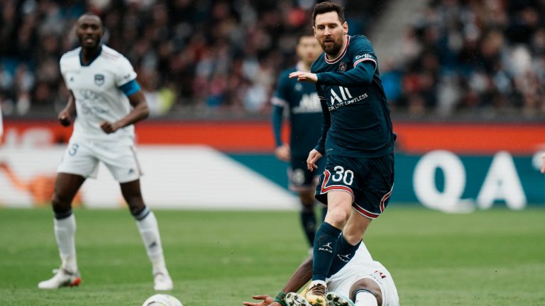 PSG's Lionel Messi is tackled by Bordeuax's Jean Onana during the French League One soccer match between Paris Saint-Germain and Bordeaux at the Parc des Princes stadium in Paris, France, Sunday, March 13, 2022. (Thibault Camus/AP)