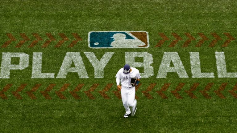 San Diego Padres left fielder Allen Cordoba passes a logo for Play Ball, an initiative from Major League Baseball and USA Baseball, during the fifth inning of a baseball game against the Colorado Rockies on June 3, 2017, in San Diego. (Gregory Bull/AP)