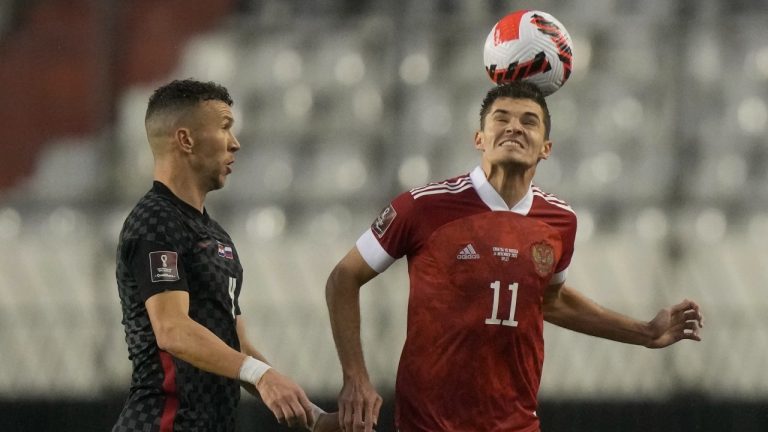 Russia's Roman Zobnin and Croatia's Ivan Perisic challenge for the ball during the World Cup 2022 group H qualifying soccer match between Croatia and Russia at the Poljud stadium in Split, Croatia, Sunday, Nov. 14, 2021. (Darko Bandic/AP Photo)